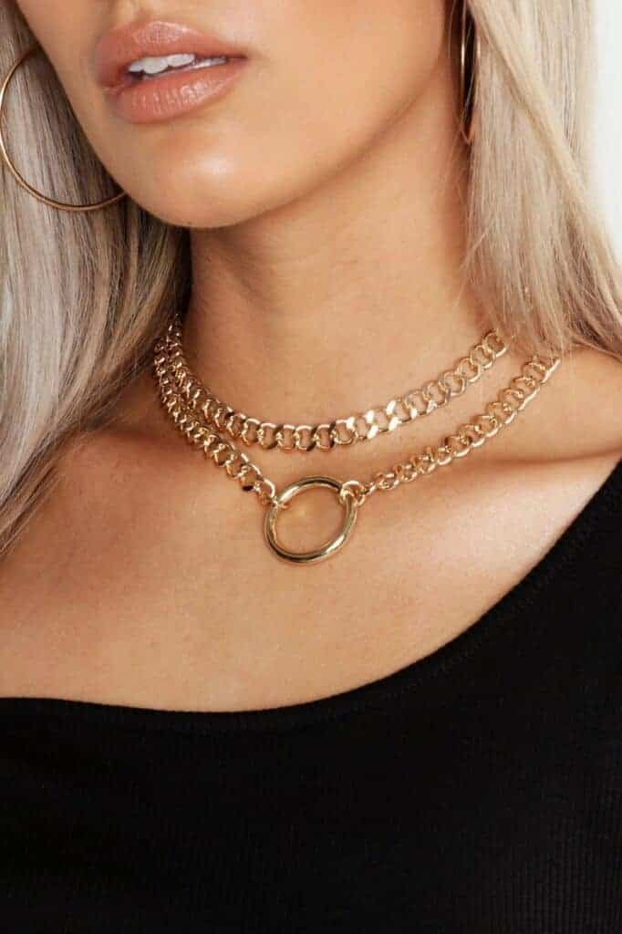 Blonde woman wearing double gold chain choker with o-ring
