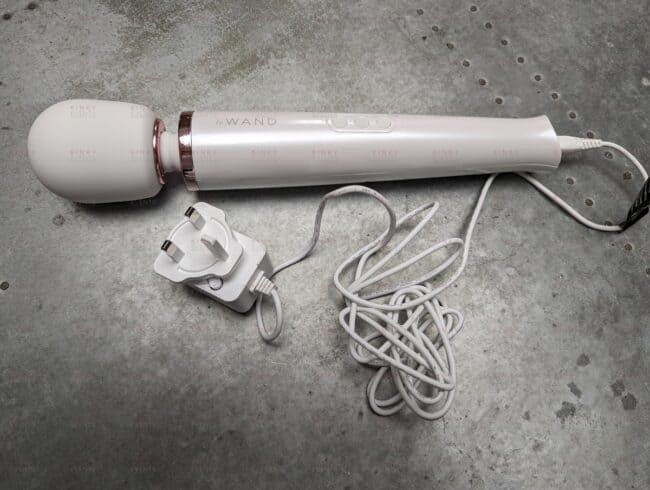 The Le Wand Original Massager with the charging cable.